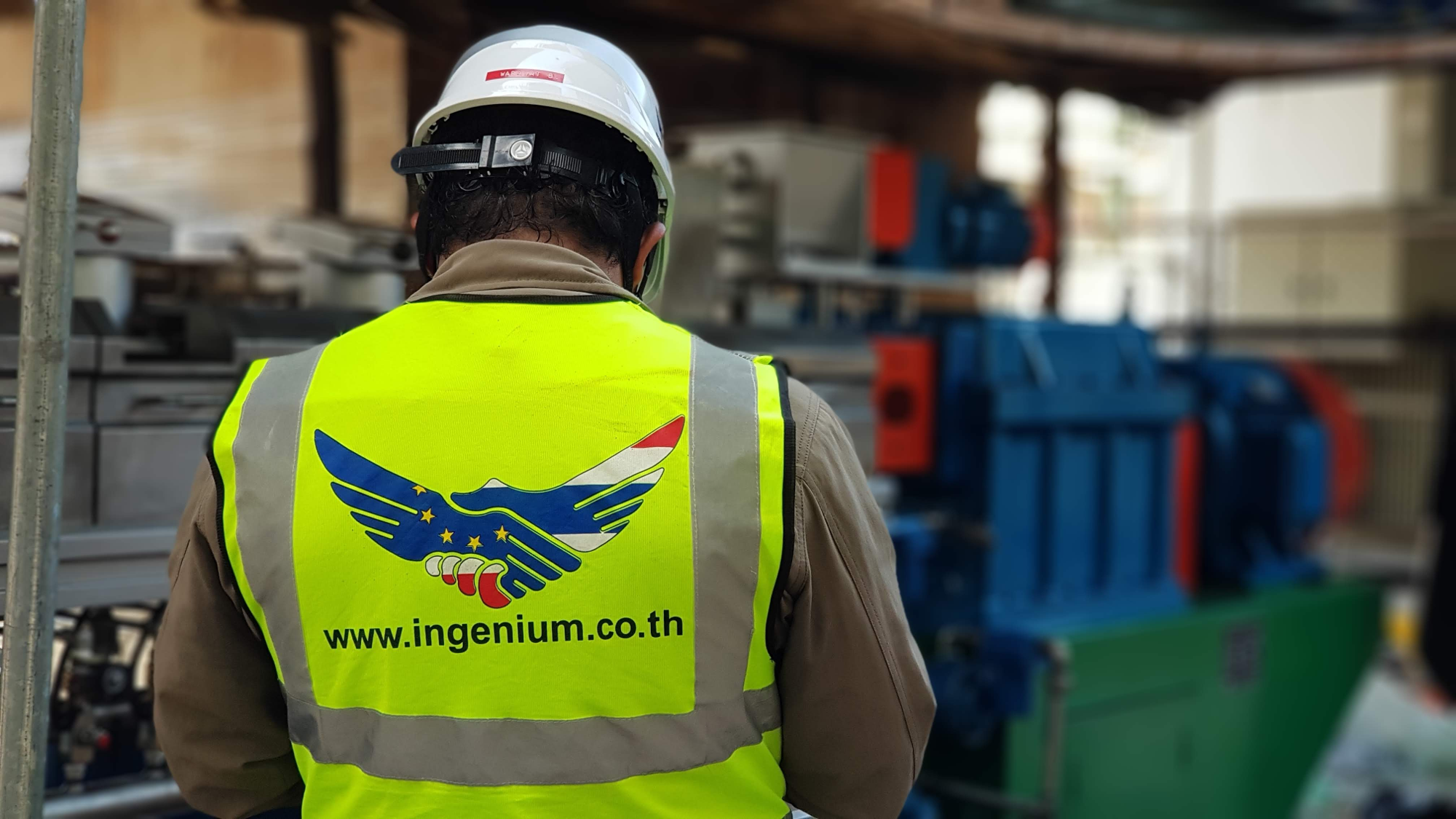 INGENIUM site team member wearing a hard hat and high-visibility vest